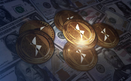 ThorChain RUNE cryptocurrency golden coin over Dollar banknotes. Online payment and crypto money...