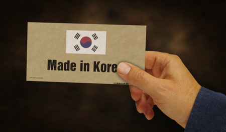 Made in Korea box in hand. Manufacturing and delivery. Product factory, import and export. Abstract concept 3d illustration.の写真素材