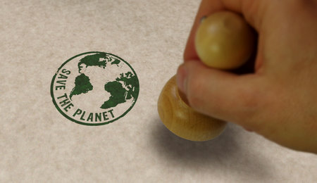 Save the planet stamp and stamping hand. World environmental protection concept.の写真素材