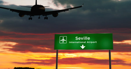 Airplane silhouette landing in Seville, Spain. City arrival with airport direction signboard and sunset in background. Trip and transportation concept 3d illustration.の写真素材