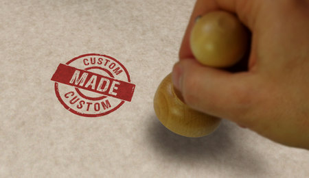 Custom made stamp and stamping hand. Handmade craft manufacturing concept.の写真素材