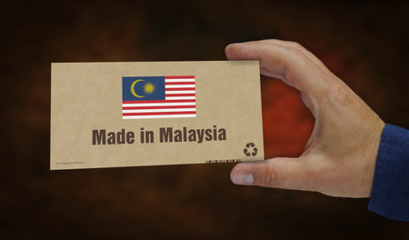 Made in Malaysia box production line. Malaysian flag manufacturing and delivery. Product factory, import and export. Abstract concept 3d illustration.の写真素材