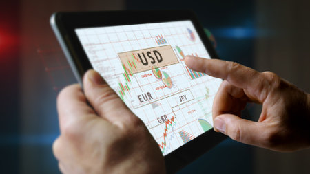 Currencies world dollar euro yen and pound money charts and graphs diagram on touchscreen pad display. Finger touch tablet screen in hand. Digital analysis and report illustration.の写真素材