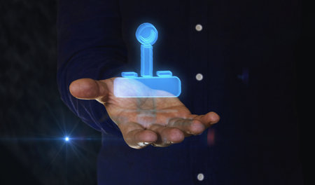 Joystick videogame and gaming 3d symbol over man hand. Cyber technology icon abstract concept.の写真素材