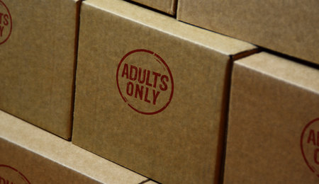 Adults only 18 plus age prohibition stamp printed on cardboard box. Under eighteen restricted concepts.の写真素材