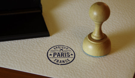 Paris arrived stamp and stamping hand. France flight arrival concept.の写真素材