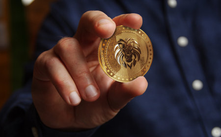 Lion symbol golden coin in hand abstract conceptの写真素材