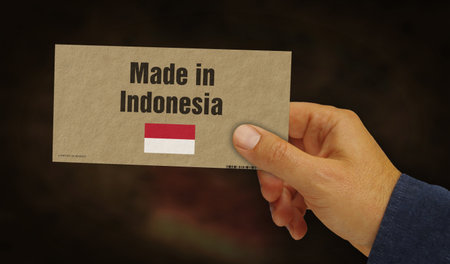Made in Indonesia label in hand. Indonesian export import manufacturing and delivery. Product factory, import and export. Abstract concept 3d illustration.の写真素材