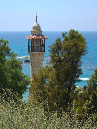 Beautiful lighthouse before blue-green waterの写真素材