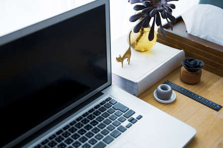 Snap photos around laptop and workspace tableの写真素材