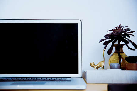 Snap photos around laptop and workspace tableの写真素材