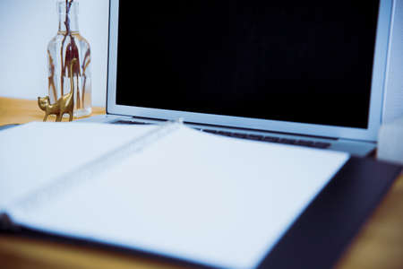 Snap photos around laptop and workspace tableの写真素材