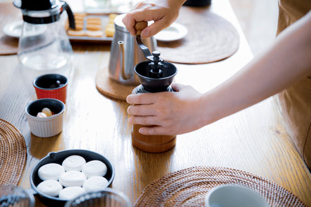 A woman entertaining at a home cafÃ©の写真素材