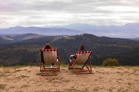 The couple is resting on deck chairsの写真素材