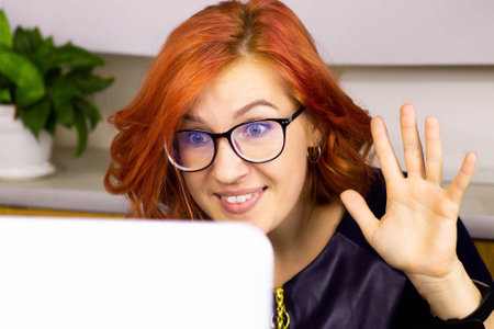 A woman with glasses at a laptop