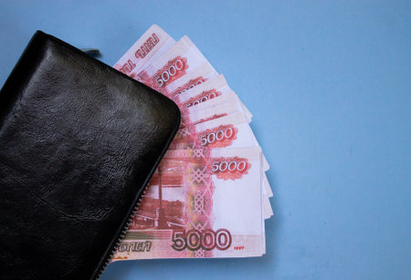working man puts money in his wallet, dirty fingers of a worker, money, hard work,hands with wallet
