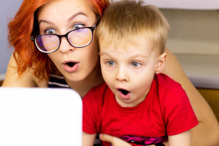 mother and child look at the laptopの写真素材