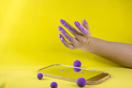 A girls hand holds a nail polish brush