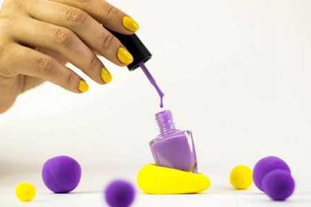 A girls hand opens nail polishの写真素材