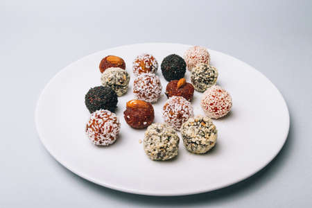 sweets from dried fruits with nuts and sesame seeds Tasty energy balls with dried fruits and nuts in...