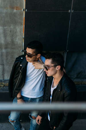 beautiful and attractive guy is standing in the city, posing. walk around the city in black glasses. communication. meeting friends.の写真素材