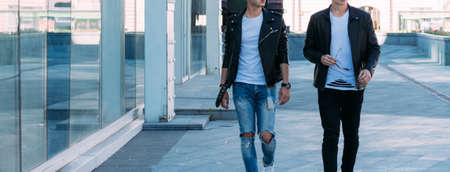 beautiful and attractive guy is going in the city, posing. dressed in a black leather kurta, white...
