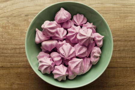 Purple Bizese are in the green plate that stands on the tableの写真素材