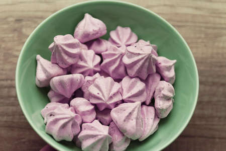 Purple Bizese are in the green plate that stands on the tableの写真素材