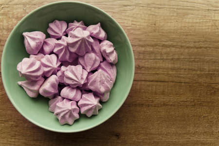 Purple Bizese are in the green plate that stands on the tableの写真素材