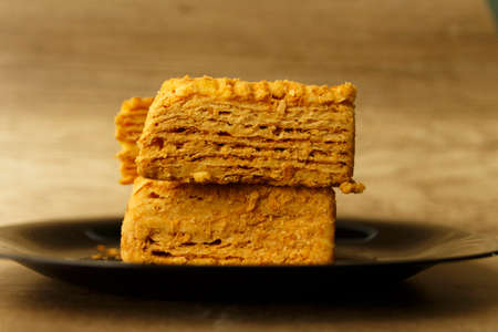 pieces of puff cake Napoleon lie on a plateの写真素材