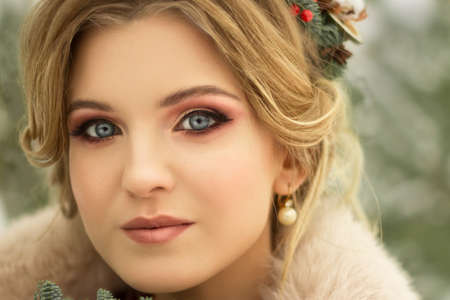 beautiful girl with flowers in her hair in winter, bride, portrait, blondeの写真素材