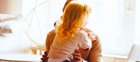 the man hugs the girl, the girl hugs the daddyの写真素材