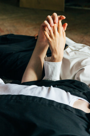 Holding hands. Lovers couple holding hands in a room. Hand in hand.の写真素材
