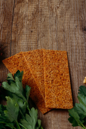 the concept of proper nutrition: salad and tree rusk flour from a rye flour lie on a wooden tableの写真素材