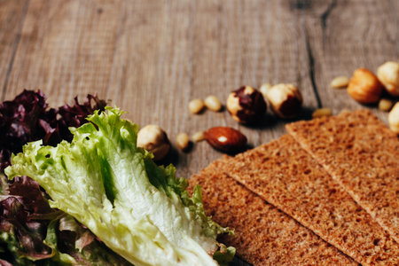 nuts, crackers, calad lie on a wooden table, the concept of proper nutritionの写真素材