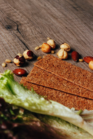 nuts, crackers, calad lie on a wooden table, the concept of proper nutritionの写真素材