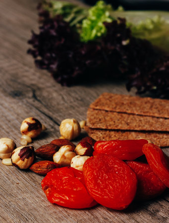 hazelnut, bread, dry apricot lie on a wooden table, the concept of proper nutritionの写真素材