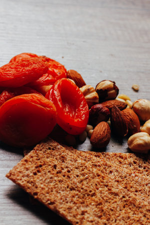 dry apricot and nuts lie on a wooden table, the concept of proper nutritionの写真素材