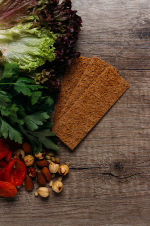 hazelnut, bread, dry apricot lie on a wooden table, the concept of proper nutritionの写真素材