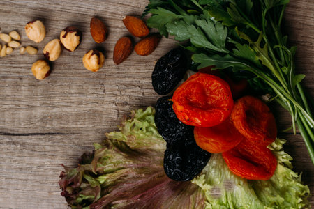 hazelnut, bread, dry apricot lie on a wooden table, the concept of proper nutritionの写真素材