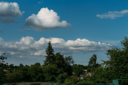 Cumulus clouds over a village in the Black Forest. summer for dreamsの写真素材