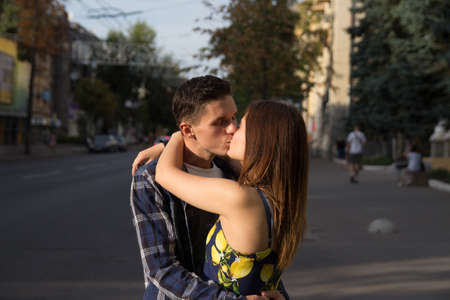 the guy and the girl are kissing on the background of the road, the city.love, a dateの写真素材
