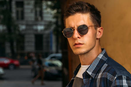 close-up of a man whish sunglasses, male portrait. Close up shot of young man on country.Caucasian male model wearing sunglasses.buy glassesの写真素材