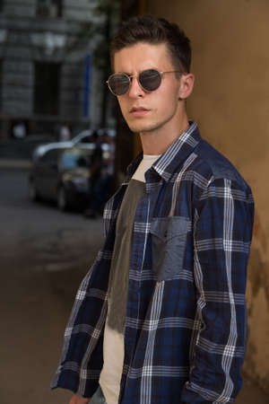 close-up of a man whish sunglasses, male portrait. Close up shot of young man on country.Caucasian male model wearing sunglasses.buy glassesの写真素材