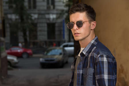 close-up of a man whish sunglasses, male portrait. Close up shot of young man on country.Caucasian male model wearing sunglasses.buy glassesの写真素材