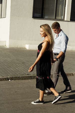 happy couple, man and woman, smiling. man holds woman and spins couple in love