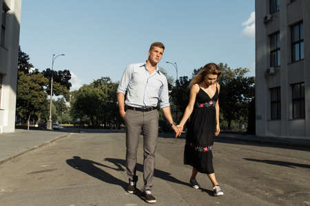 happy couple, man and woman, smiling. man holds woman and spins couple in love