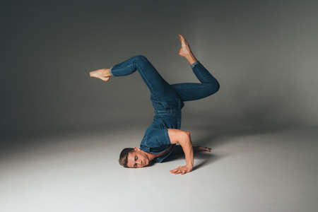 attractive guy in jeans dancing, jumping, shot of mad, crazy, cheerful, successful, lucky guy in...