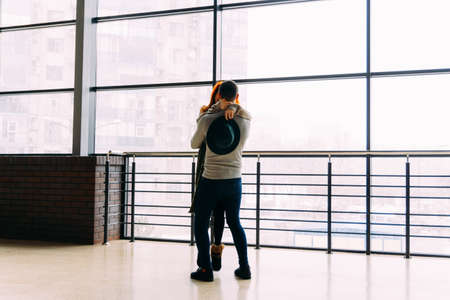 silhouette dancing, swirling couple on a window background. holding hands. love, confession, offer to get married.の写真素材