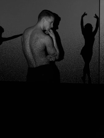 attractive man looks at the shadow of a dancing girl,dancer,professional,black and white photo.の写真素材